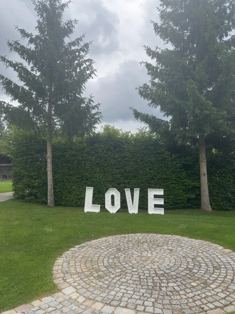 LOVE-Schriftzug auf der Rasenfläche vor den hohen Hecken im Landkulturhof Glücksbringer